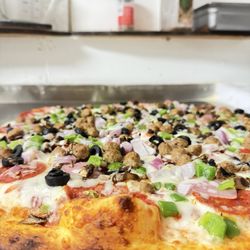 Whispering Trees Market & Deli - The works pizza - chef Jagger art piece