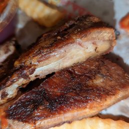 a plate of ribs and fries a plate of ribs and fries