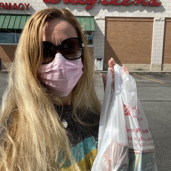 Walgreens - a woman wearing a face mask and holding a bag of groceries - Cosmetics & Beauty Supply Near Me - Jesup, Georgia