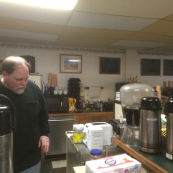 Uncommon Grounds - a man standing in a coffee shop - Coffee & Tea Near Me - Duxbury, Massachusetts