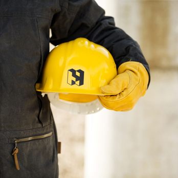 Hooper - a construction worker holding a hard hat - General Contractors Near Me - DeForest, Wisconsin Hooper - a construction worker holding a hard hat - General Contractors Near Me - DeForest, Wisconsin
