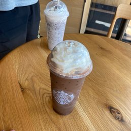 a cup of iced coffee with whipped cream on top