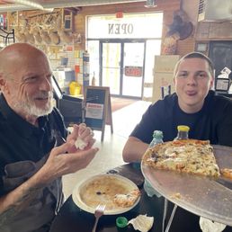 Two jokesters eating pizza