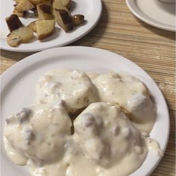 Biscuits and Gravy, fried apples, potatoes, ham egg and cheese sandwich
