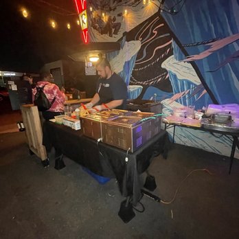 Flaccos Tacos - a man preparing food on a table - Tacos Near Me - Long Beach, California