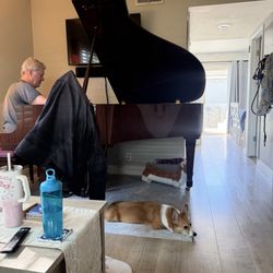 Master Piano Tuner Doug Freeze - Doug tuning our baby grand piano while our corgi supervises