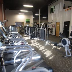 Anytime Fitness - Treads and machine weight area. Studio space in the back.
