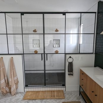 Guthrie Custom Shower Doors - Frameless double door unit with end panels on pony walls. Matte black hardware and standard clear glass, with black grids printed on glass. - Glass & Mirrors Near Me - Garden Grove, California Guthrie Custom Shower Doors - Frameless double door unit with end panels on pony walls. Matte black hardware and standard clear glass, with black grids printed on glass. - Glass & Mirrors Near Me - Garden Grove, California