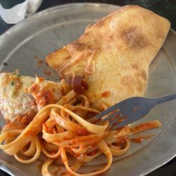 One Guy From Italy Family Restaurant - Half a calzone, fettuccine noodles with spaghetti sauce (noodles are from the chicken parm)