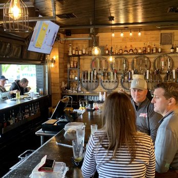 Prohibition Dunedin - a group of people sitting at a bar - Gastropubs Near Me - Dunedin, Florida Prohibition Dunedin - a group of people sitting at a bar - Gastropubs Near Me - Dunedin, Florida