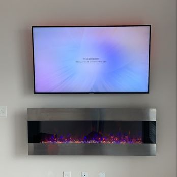 Mario Mounts - 60" Tv installed on tilt Mount with concealed wires and electric Fireplace - TV Mounting Near Me Mario Mounts - 60" Tv installed on tilt Mount with concealed wires and electric Fireplace - TV Mounting Near Me