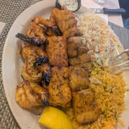 Basa, salmon, and shrimp with rice. The dish is Seafood Mixed Grill