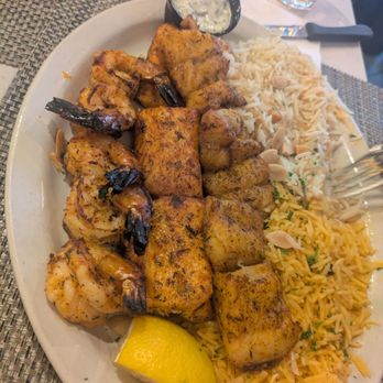 M’dakhan - Basa, salmon, and shrimp with rice. The dish is Seafood Mixed Grill - Breakfast & Brunch Near Me - Bridgeview, Illinois