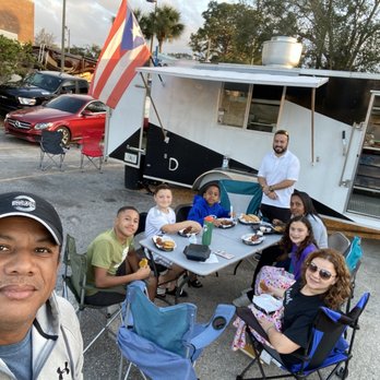 Antojitos Boricua - a group of people sitting around a table - Food Trucks Near Me - Orlando, Florida