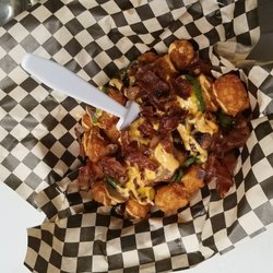 Copper Skillet On Wheels - Tater tots topped with America cheese, grilled jalapeno, grilled red onion, grilled mushroom, bacon and spicy sauce.