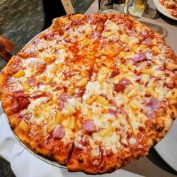 Medium pizza with extra sauce and ham and pineapple