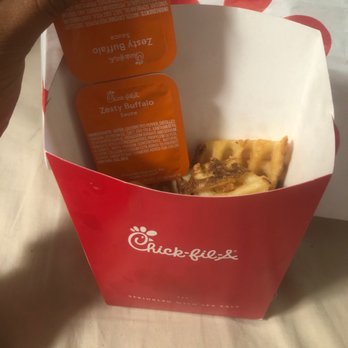 Chick-fil-A - ows a hand holding a box of food - Fast Food Near Me - Hudson Oaks, Texas