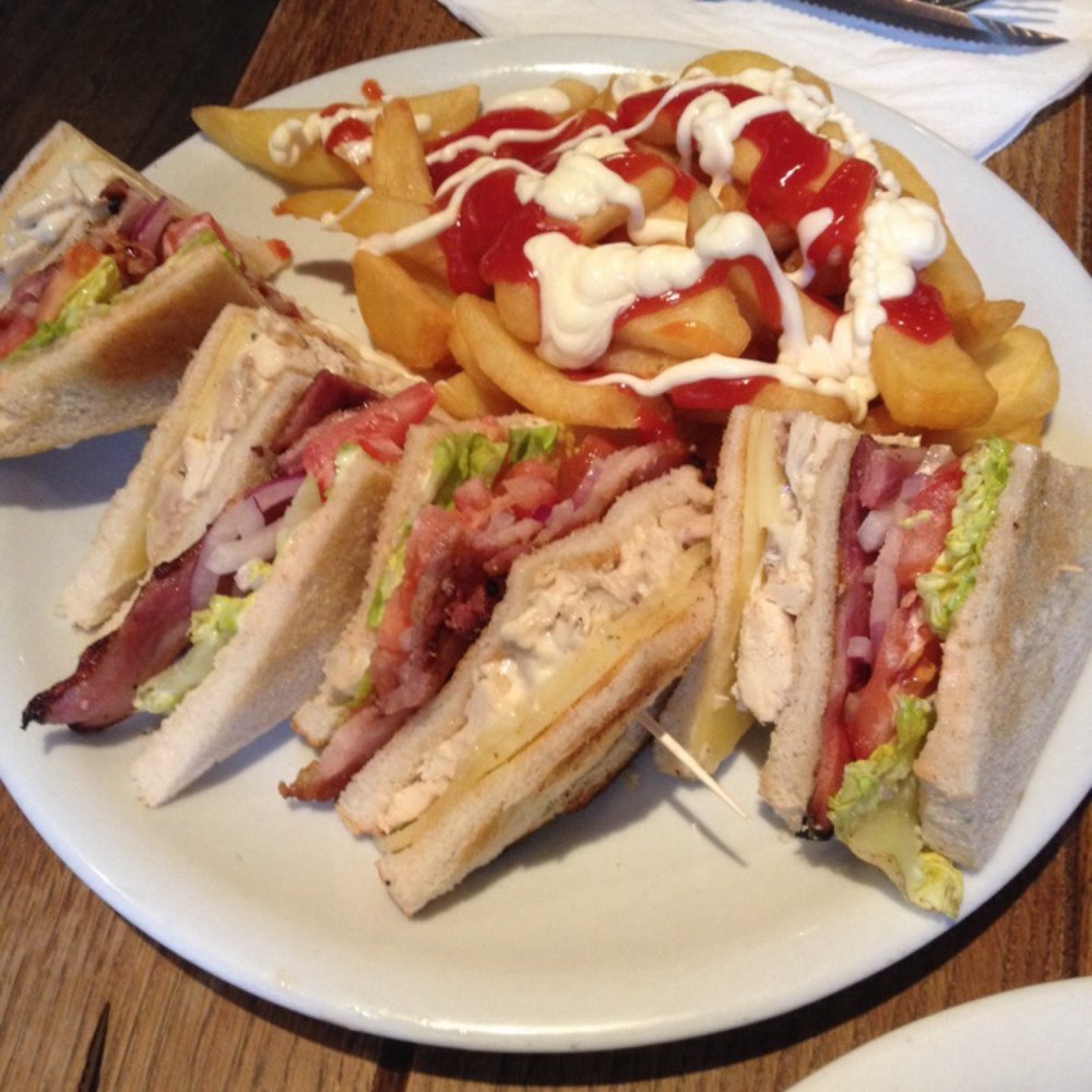 The Bountiful Cow - Club sandwich with chips and an extra load of Heinz Ketchup and Helmanns Mayonnaise. - Steakhouses Near Me - London, XGL The Bountiful Cow - Club sandwich with chips and an extra load of Heinz Ketchup and Helmanns Mayonnaise. - Steakhouses Near Me - London, XGL