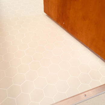 Creative Construction & Remodeling - a bathroom floor with white tile - General Contractors Near Me - Sherman Oaks, California