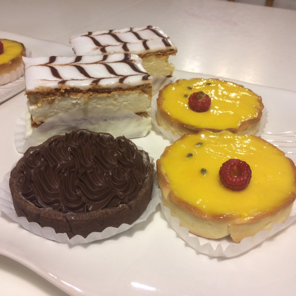 Take out desserts for our dinner party: Passion fruit Tart, Mille Feuille, Chocolate raspberry tart Take out desserts for our dinner party: Passion fruit Tart, Mille Feuille, Chocolate raspberry tart