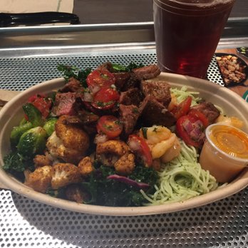 Bolay - Large bowl and ice tea. Noodles, kale, Brussels sprouts, cauliflower, steak, shrimp, tomatoes. - New American Near Me - Boca Raton, Florida