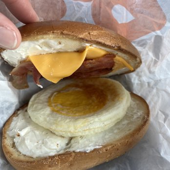 Dunkin' -  a hand holding a half eaten sandwich - Donuts Near Me - Mesa, Arizona