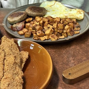 Huevos Etc - Classic breakfast with sausage and bacon, fried potatoes, and over medium eggs with a side of catfish - Pancakes Near Me - Indianapolis, Indiana