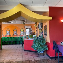 Front lobby - The image shows the interior of a Thai restaurant with vibrant wall colors, decorative elements, and seating arrangements.