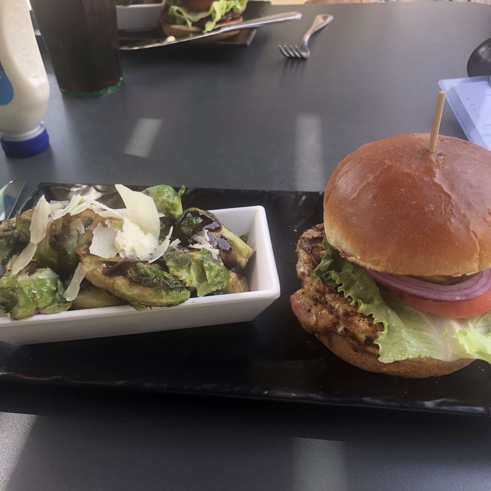 Blackened pork tenderloin served on a brioche bun with balsamic & Parmesan roasted Brussels sprouts