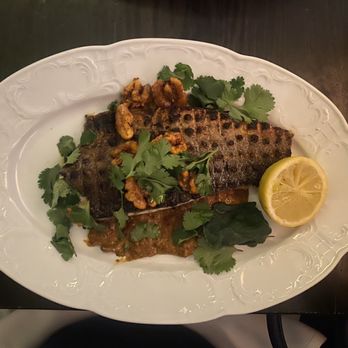 Suraya - Samke Harra (grilled branzino filet, served with a spicy sauce of red peppers, tomatoes, walnuts, & pine nuts) - Lebanese Near Me - Philadelphia, Pennsylvania Suraya - Samke Harra (grilled branzino filet, served with a spicy sauce of red peppers, tomatoes, walnuts, & pine nuts) - Lebanese Near Me - Philadelphia, Pennsylvania