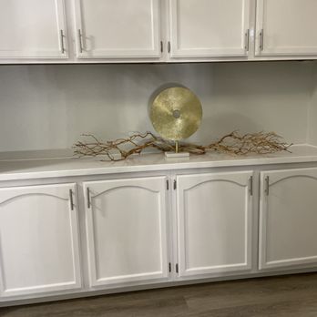 MOS Builders - a white cabinet with a gold plate on top - General Contractors Near Me MOS Builders - a white cabinet with a gold plate on top - General Contractors Near Me