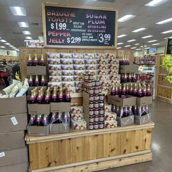 Trader Joe's - Ginger jars, bottles, and gift boxes are arranged on a wooden display at Trader Joe's in Concord, CA, with a blackboard sign above advertising various products. - Grocery Near Me - Concord, California