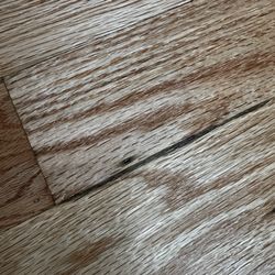 Ace Wood Flooring - "Repaired" kitchen area they missed, as seen by the dark line.
