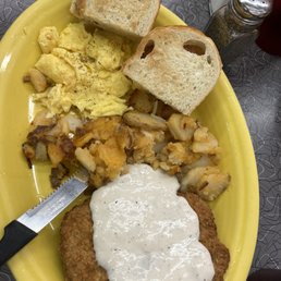Country Fried Steak with potatoes and scrambled eggs. Country Fried Steak with potatoes and scrambled eggs.