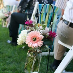 Shepherds hooks with hanging mason jars filled with flowers or candles lining the aisle. http://www.motifeventrentals.com