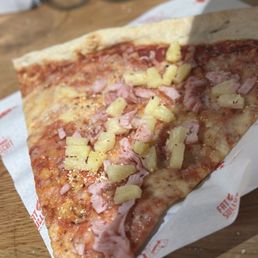 Big ass slice of pizza.  Delicious   I ordered Canadian bacon and pineapple.  This New York style pizza which is my favorite.