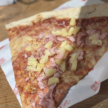 Atomic Cowboy - Centennial - Big ass slice of pizza.  Delicious   I ordered Canadian bacon and pineapple.  This New York style pizza which is my favorite. - Pizza Near Me - Centennial, Colorado