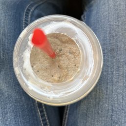 a cup of oatmeal with a straw in it