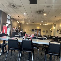 CJ's Corner - Basic banquet type chairs. Busted tables. The lights look streaked at top from the smoke.