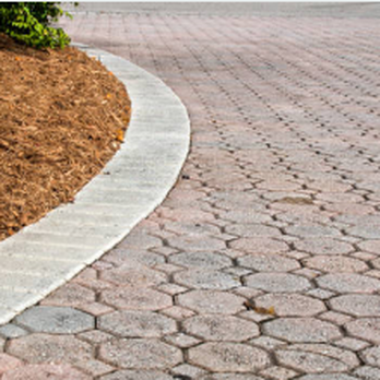 Custom Lawns - a cobblestone walkway with a concrete edging - Tree Services Near Me Custom Lawns - a cobblestone walkway with a concrete edging - Tree Services Near Me