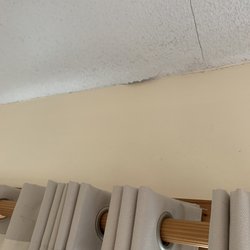 Sun Realty - Peeling popcorn ceiling.