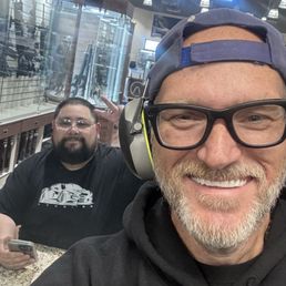 I'm inside the shooting range and my buddy is at the table on the other side of the glass watching us shoot! I'm inside the shooting range and my buddy is at the table on the other side of the glass watching us shoot!