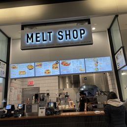 a man and a woman standing in front of a counter a man and a woman standing in front of a counter