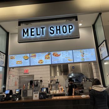 Melt Shop - a man and a woman standing in front of a counter - Sandwiches Near Me - Staten Island, New York Melt Shop - a man and a woman standing in front of a counter - Sandwiches Near Me - Staten Island, New York