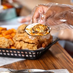 Red Crab Juicy Seafood - Fresh oyster on the half shell, drenched in bold Cajun garlic butter--juicy, savory, and bursting with seafood flavor.