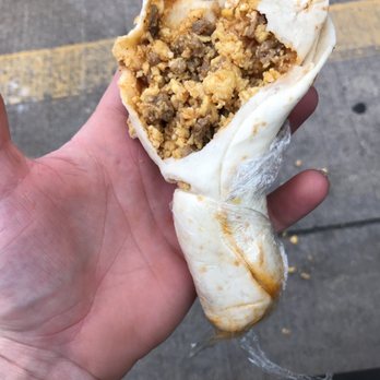 Sugar Land Donuts - a hand holding a burrito - Donuts Near Me - Sugar Land, Texas Sugar Land Donuts - a hand holding a burrito - Donuts Near Me - Sugar Land, Texas