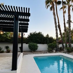 Greenheart Pergolas - Patio Cover in front of the pool in a backyard in Mesa