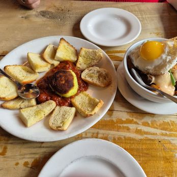 Fat Cats - Left- Warm goat cheese over housemade marinara with crispy bread points. Right- kimchi potatoes with a perfectly cooked, runny egg! Wow! - New American Near Me - Cleveland, Ohio Fat Cats - Left- Warm goat cheese over housemade marinara with crispy bread points. Right- kimchi potatoes with a perfectly cooked, runny egg! Wow! - New American Near Me - Cleveland, Ohio