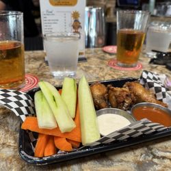 Highlands Sports Bar & Grill - Chicken wings with sauces on the side.