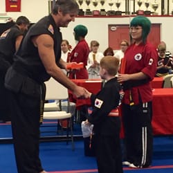 Price's Karate - Graduation to solid orange belt with Mr. Price doing the belt honors.